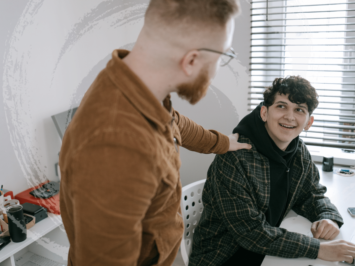 A man checking in with a teenager, symbolizing managing an anxiety disorder