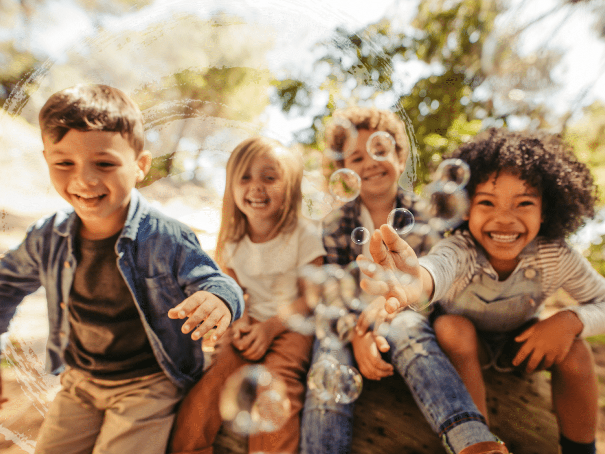 A group of children blowing bubbles, symbolizing emotional dysregulation and adhd