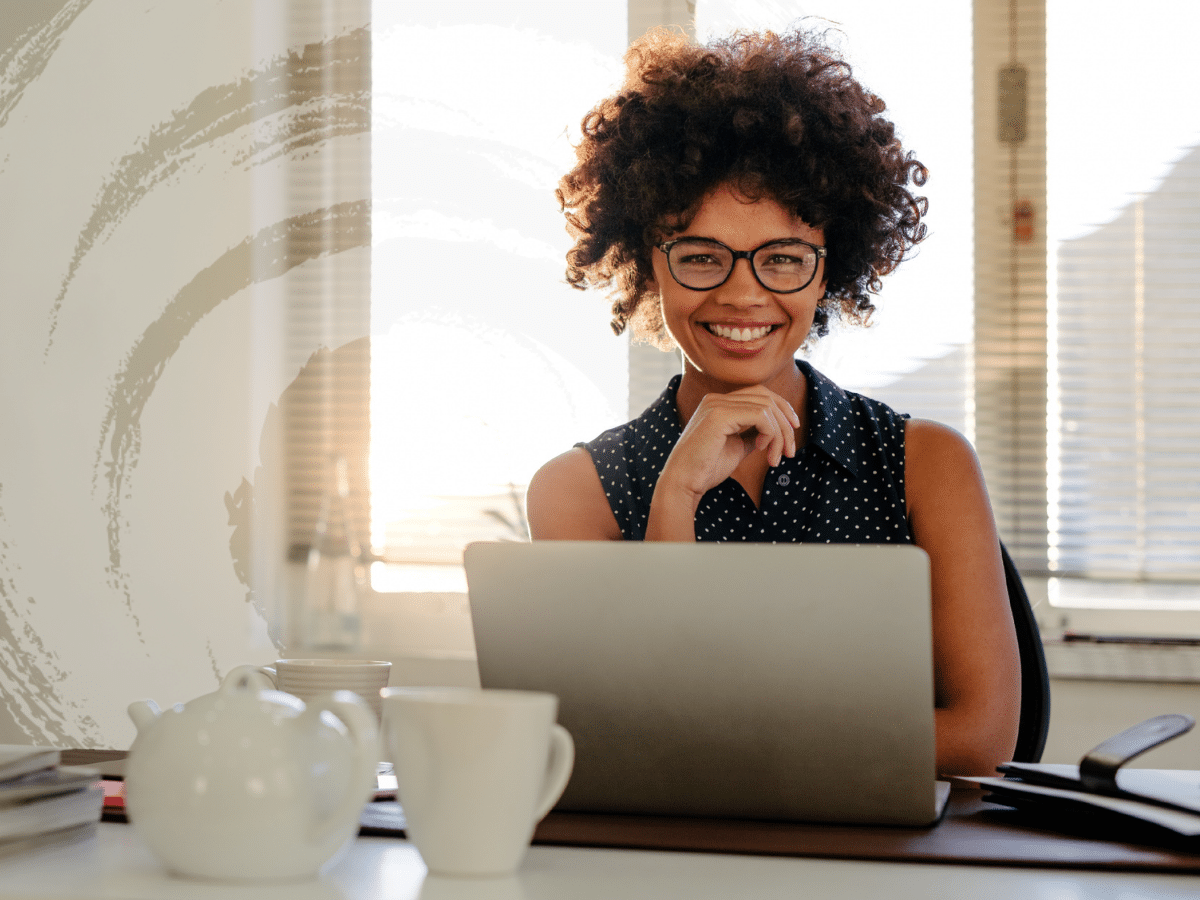 A woman sitting before a laptop, symbolizing how some people suffer from high-functioning anxiety