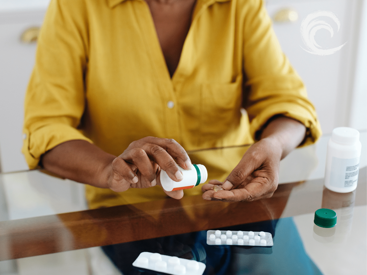 A woman taking prescription medication, symbolizing the awareness needed around medication side effects