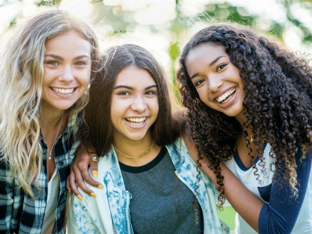 Three teenage girls, symbolizing PMDD vs PMS