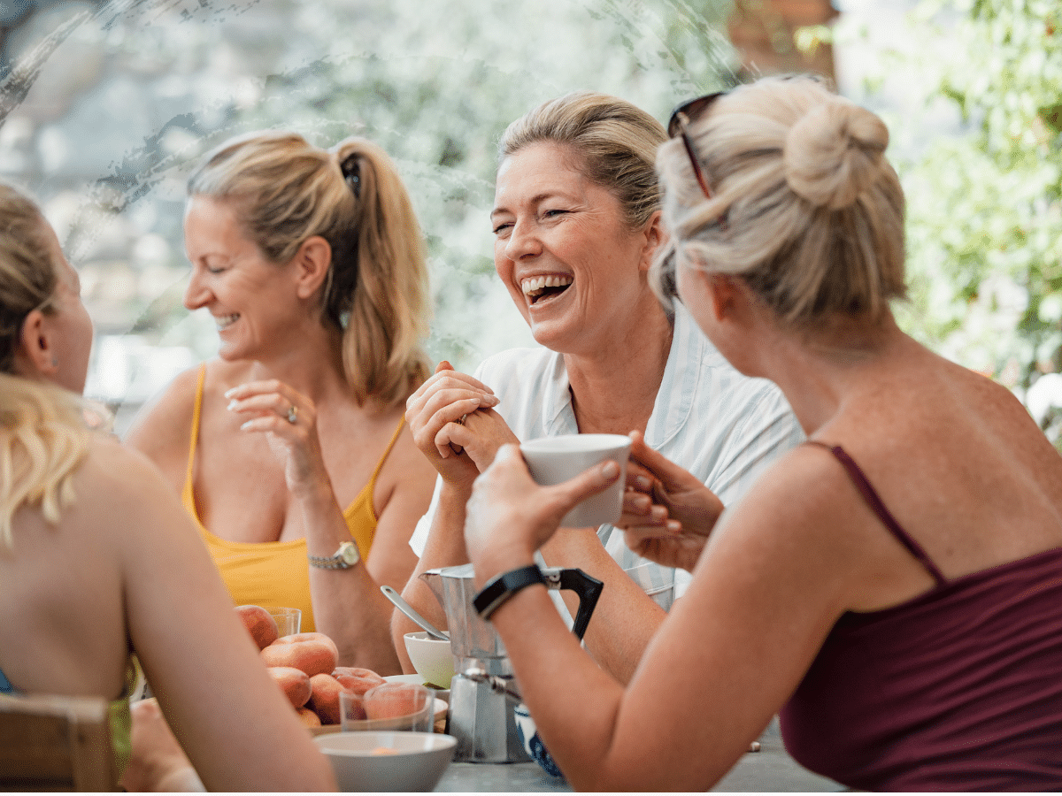 A group of women gathered around a table, symbolizing signs of ADHD in women