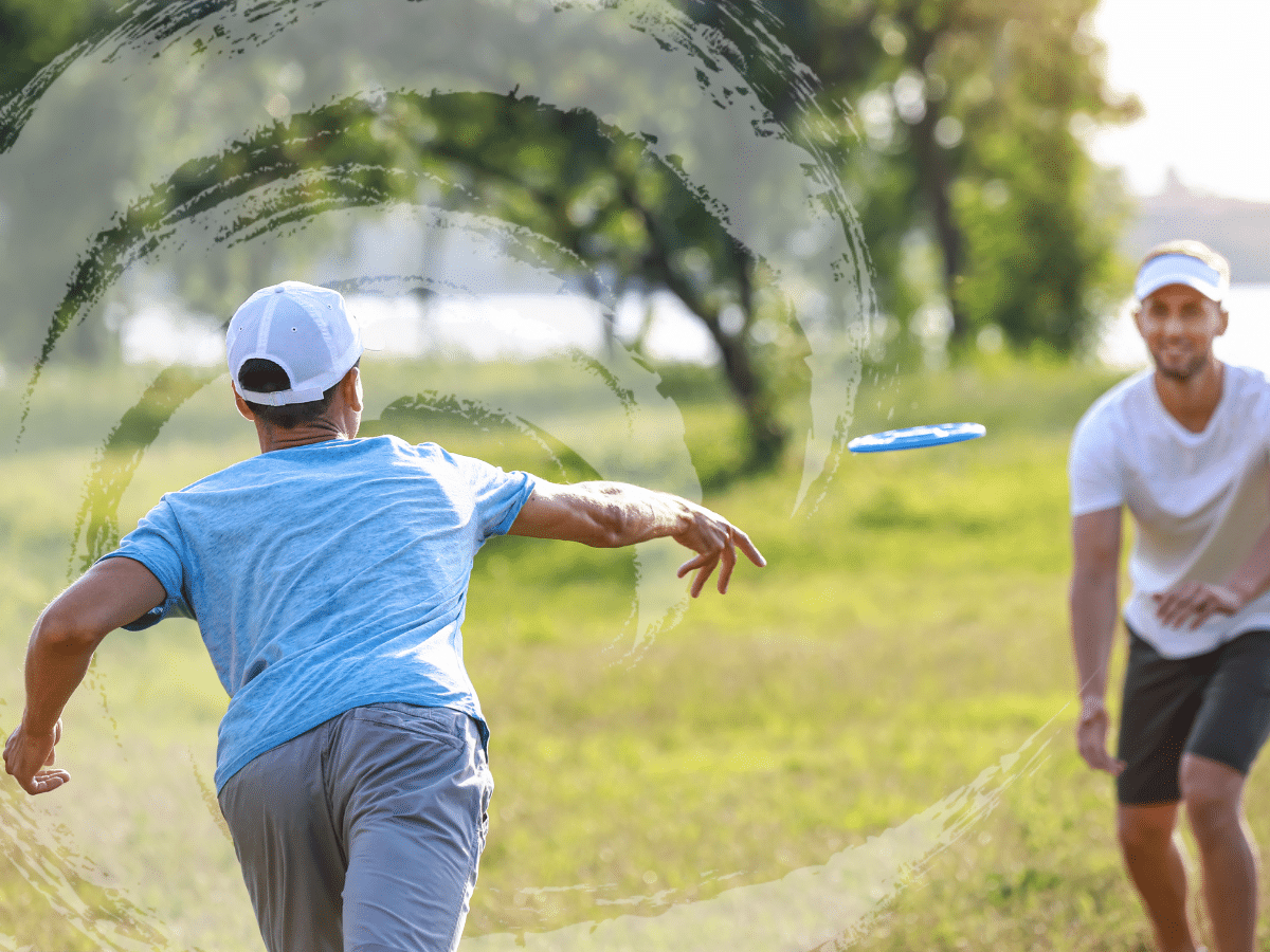 Two men playing frisbee, symbolizing a discussion on how TMS for depression works.