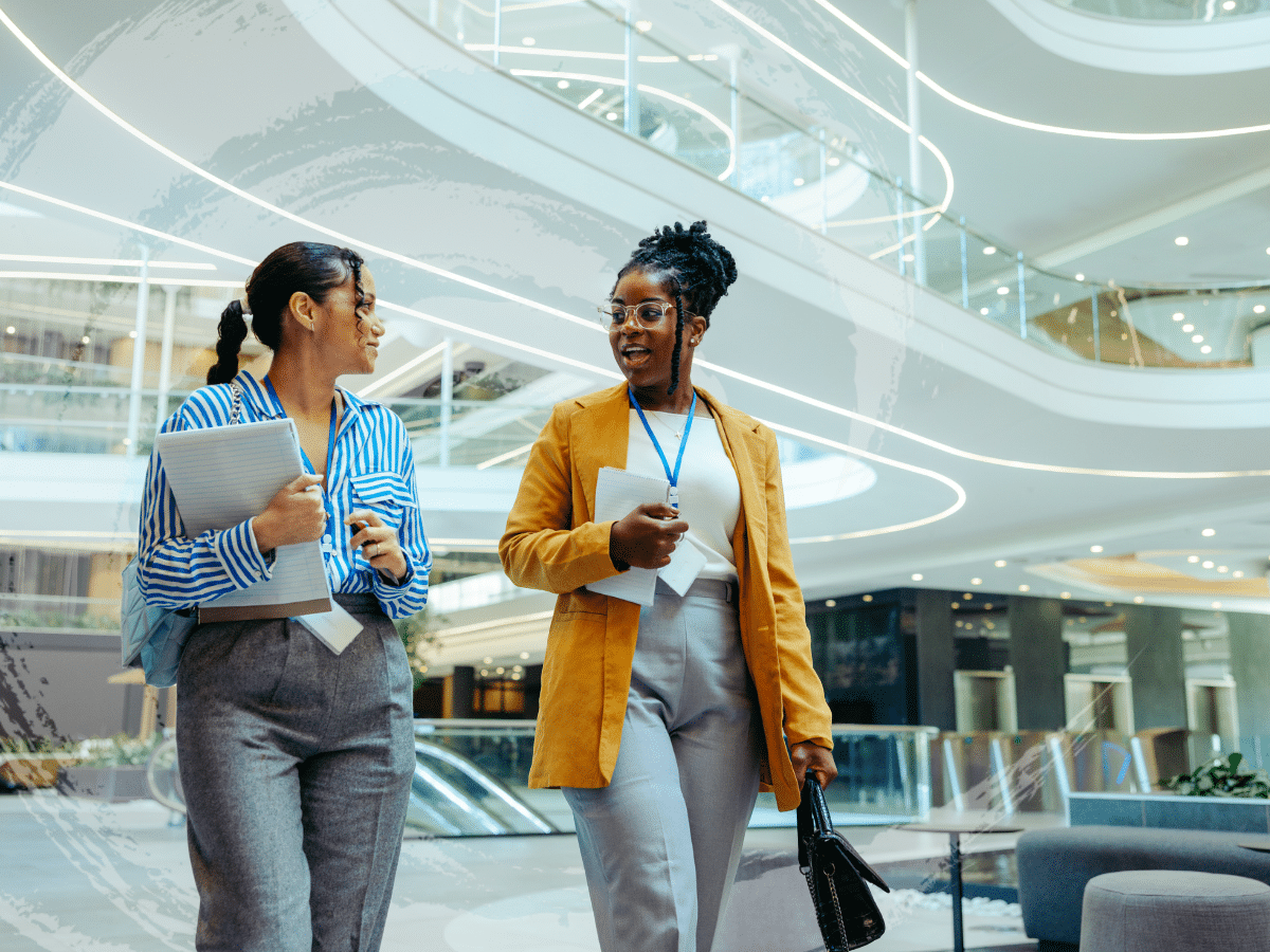 Two women walking through a building carrying paperwork, symbolizing a general discussion about anxiety symptoms