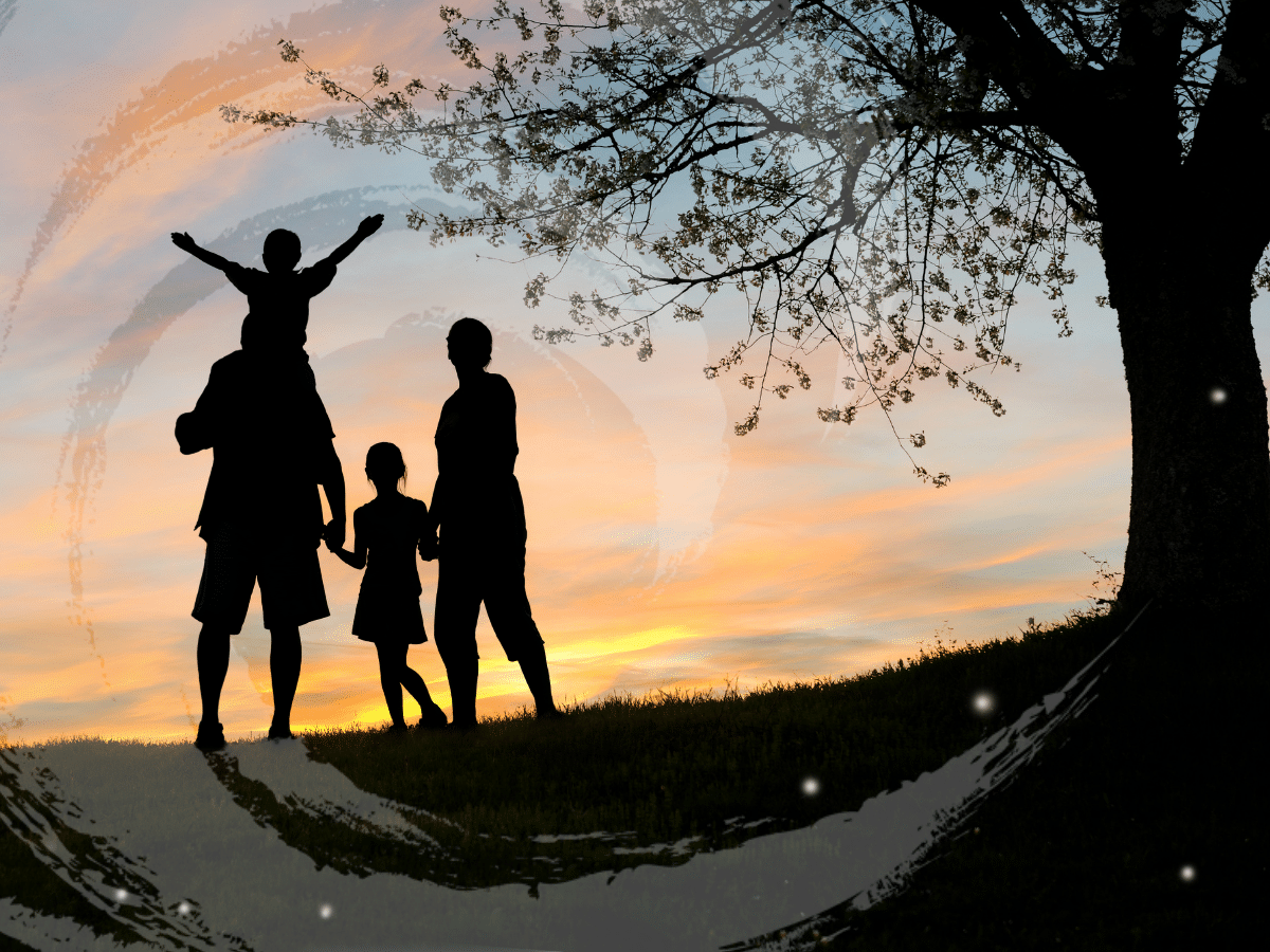 A family gathered beneath a tree watching the sun set, symbolizing healing after complex PTSD