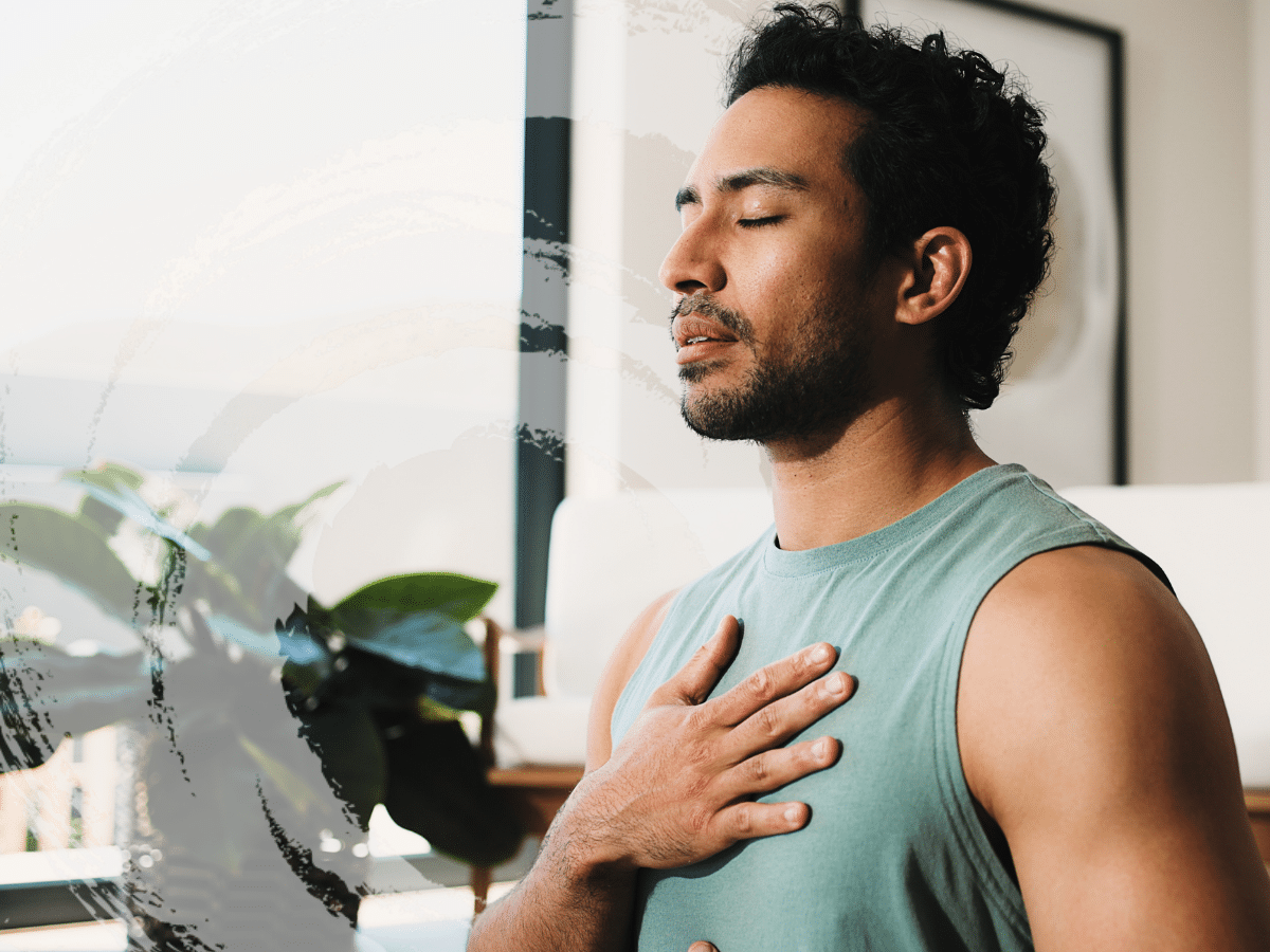 A man meditating with his hand on his chest, symbolizing the benefits of holistic psychiatry