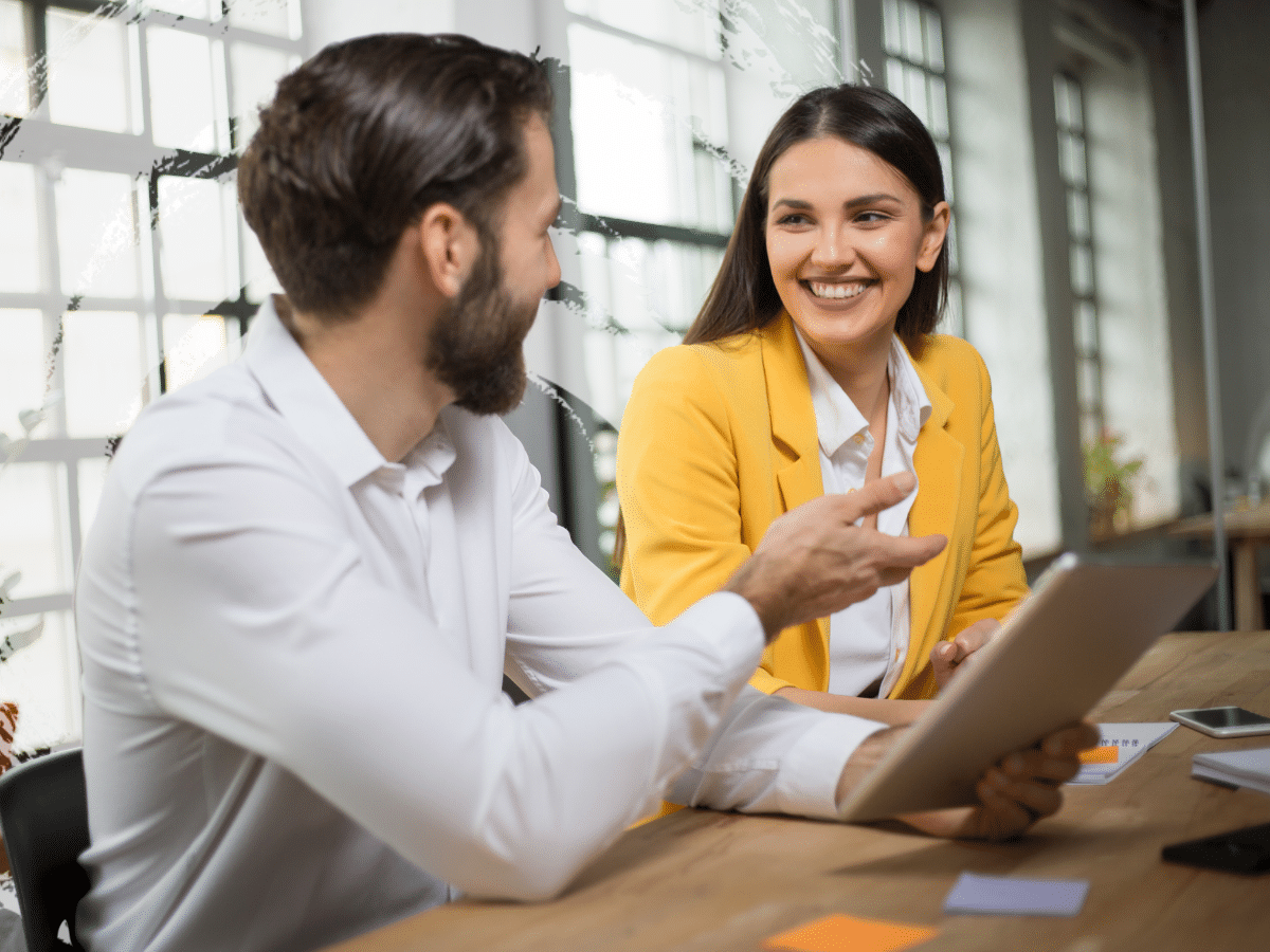 two people talking at work, symbolizing imposter syndrome