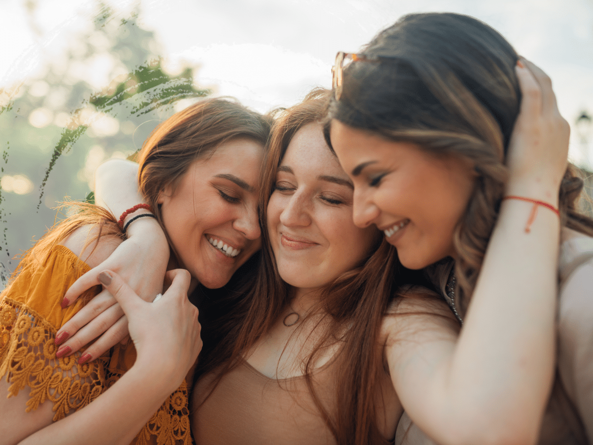 Three friends hugging each other, symbolizing ketamine for ptsd
