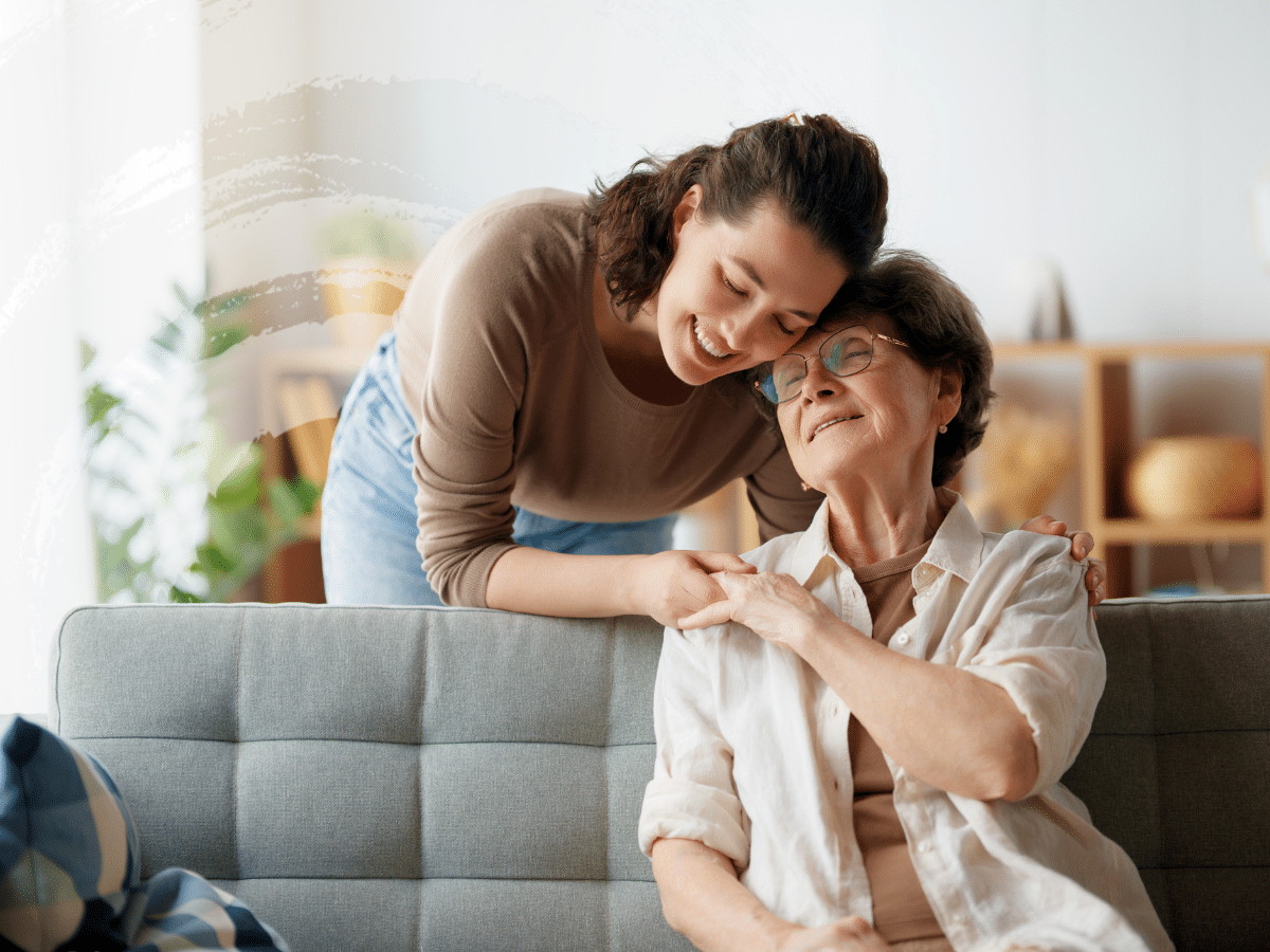 A young woman caring for an older woman, symbolizing the work of mental health caregivers