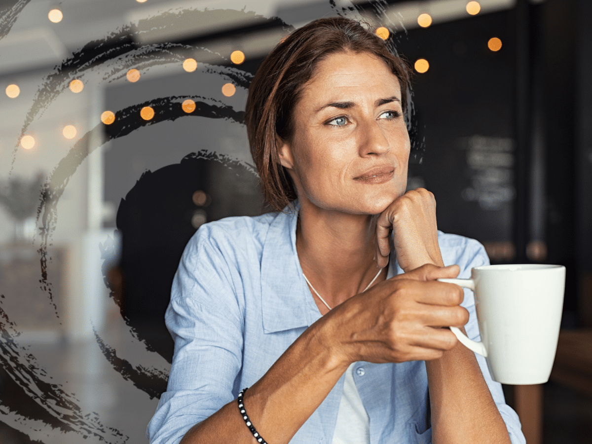 A woman holding a cup of coffee and thinking, symbolizing how people consider myths about mental health