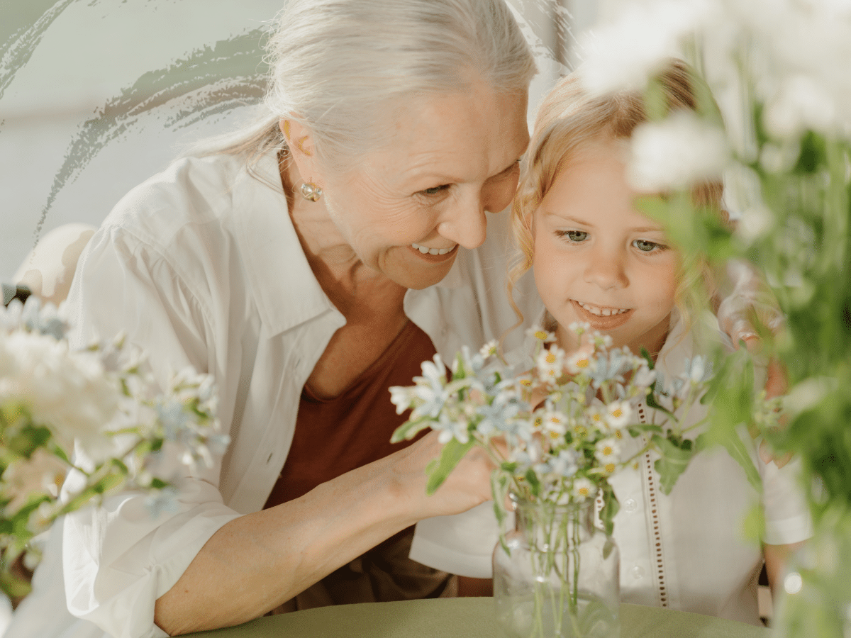 A girl with her grandmother arranging flowers, symbolizing situational depression