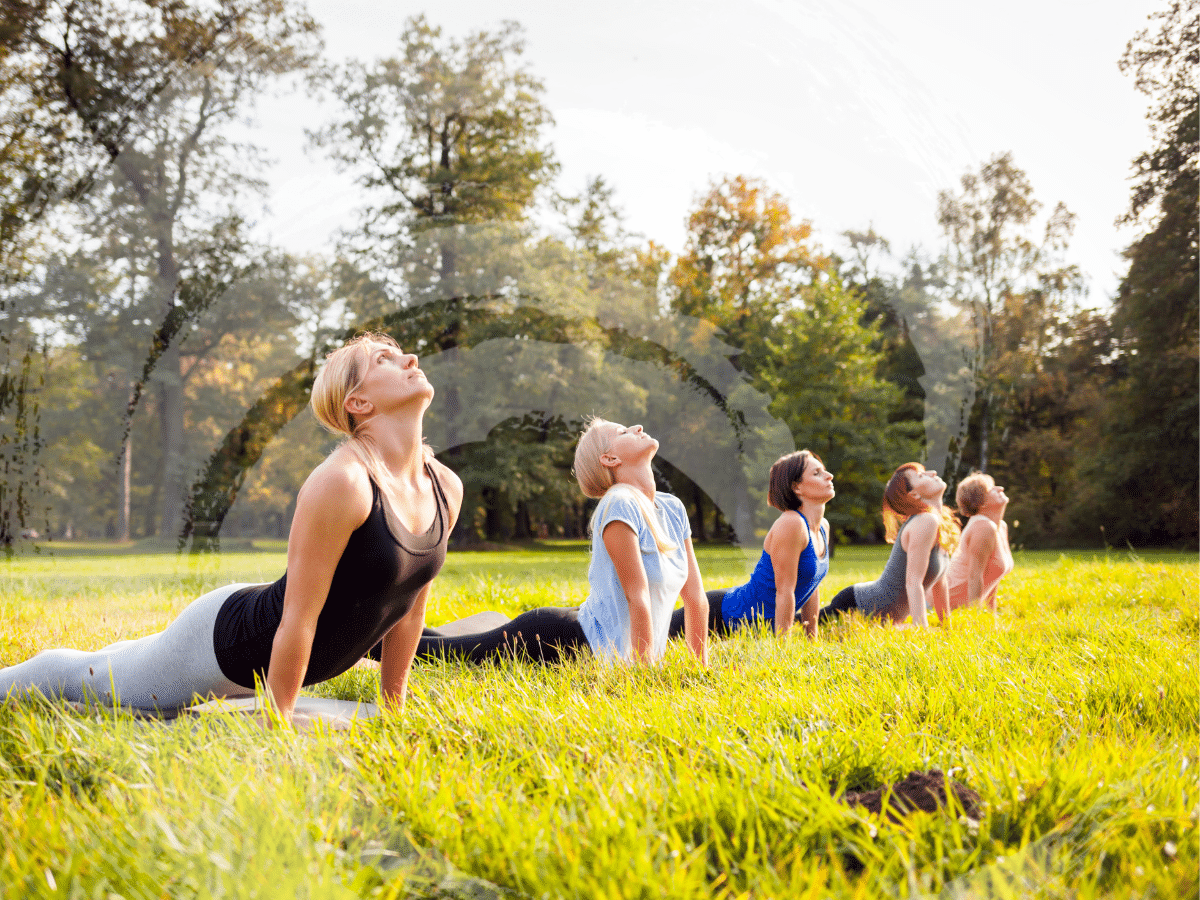 A group fo women doing yoga outdoors, symbolizing the steps in Spravato treatment