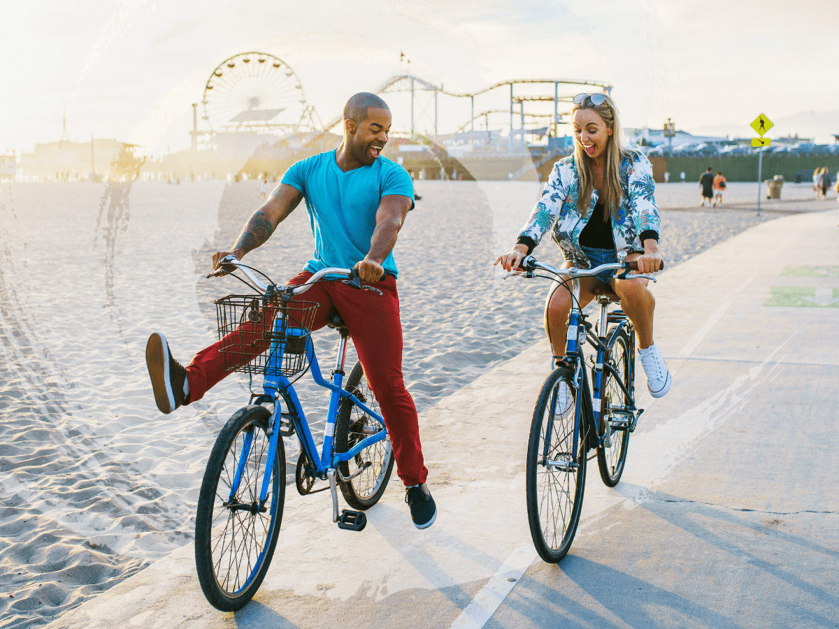 Two people riding bikes along the beach, symbolizing the energy and balance supported by theta burst stimulation treatment for depression.