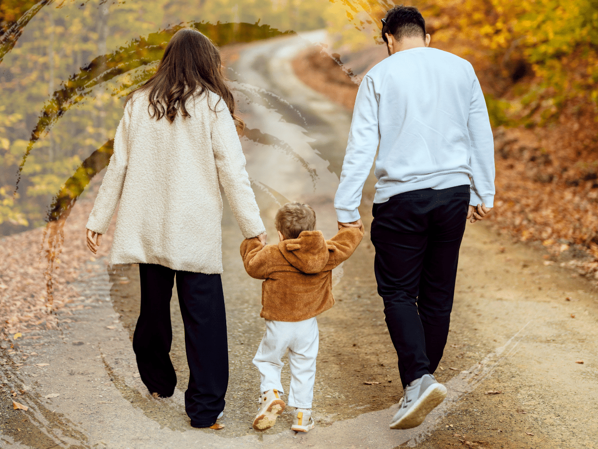 A family of three walking and holding hands, sympolizing what cuases ADHD